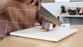 A person demonstrating knife safety in the kitchen.
