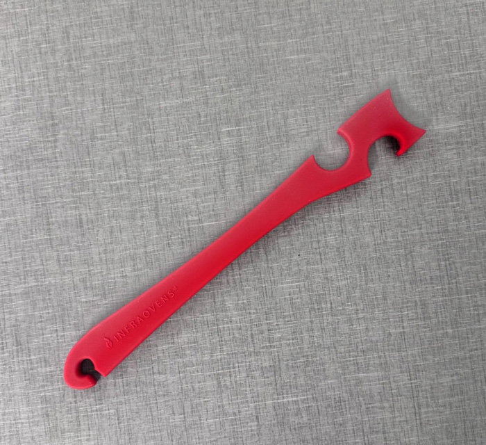 A photo of a red silicone oven push/pull stick.