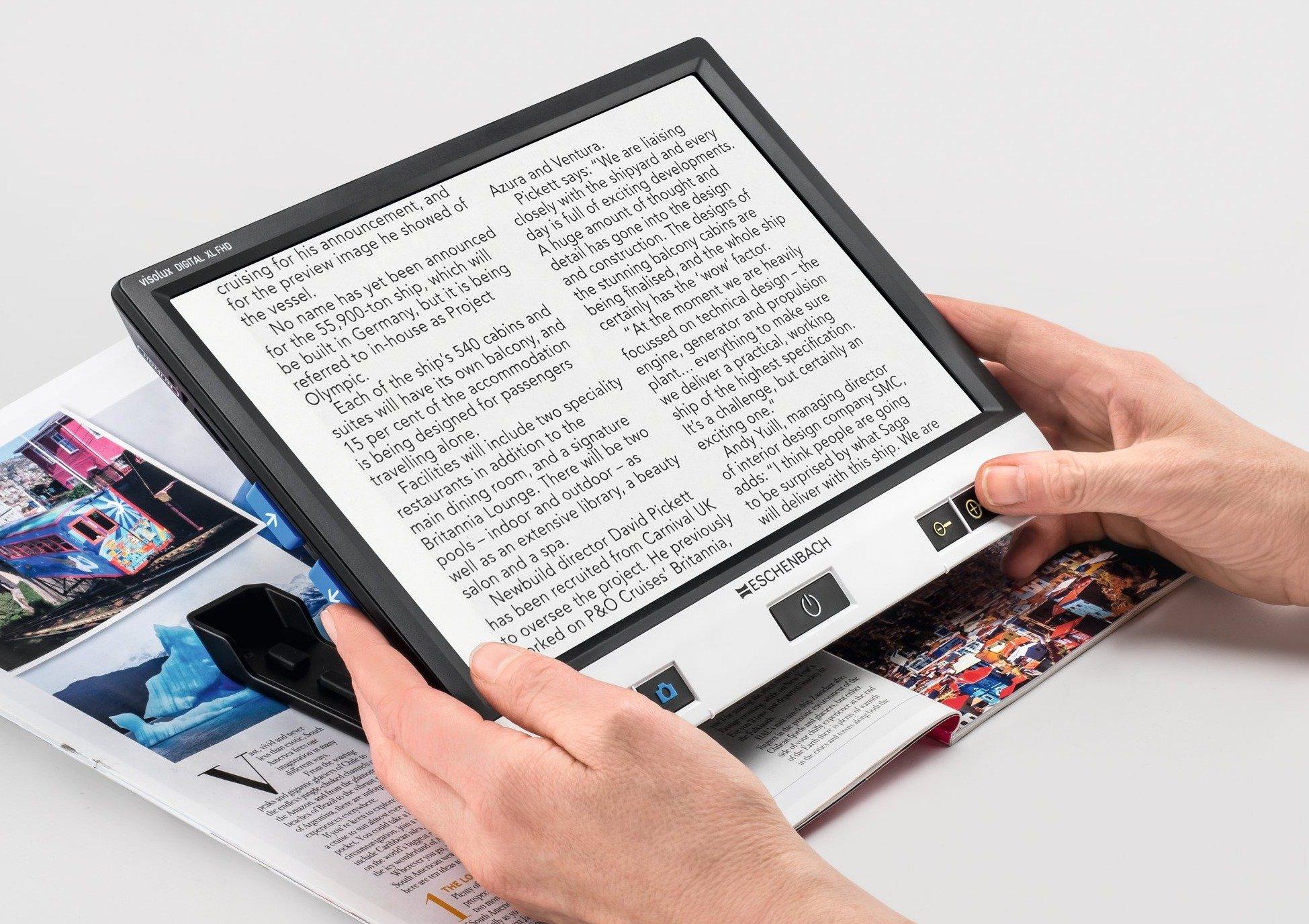The Eschenbach Visolux Digital HD video magnifier is used to enlarge an article in a magazine.
